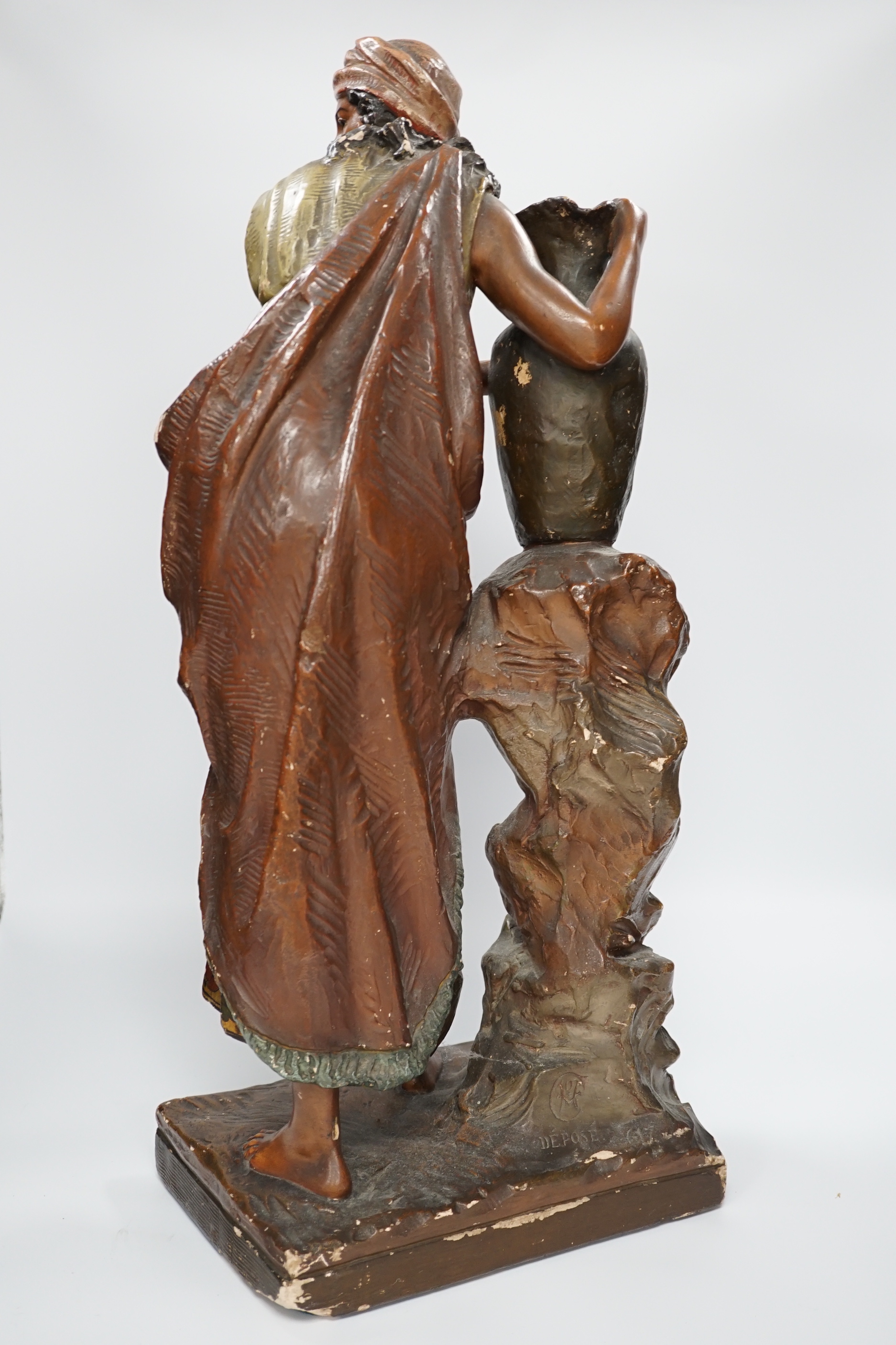 A painted plaster figure of Rebecca at the well, 58cm high